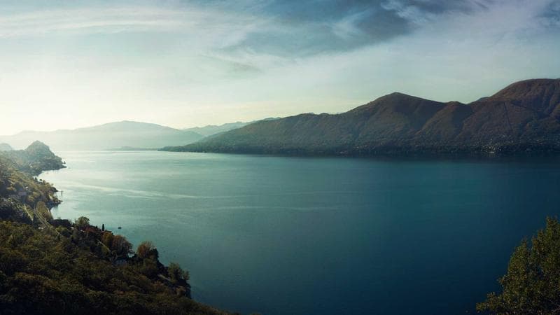 A futuristic city at night, flying cars, neon rain, drone shot descending between skyscrapers